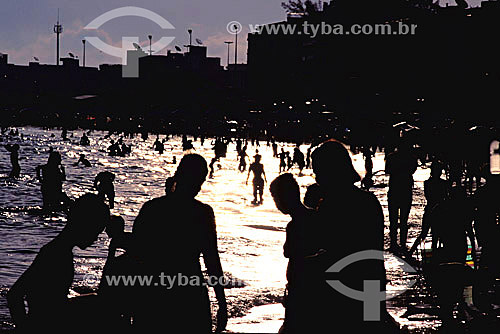  The silhouette of swimmers at Praia do Forte Beach (Fort Beach) - Cabo Frio city - Rio de Janeiro state - Brazil 