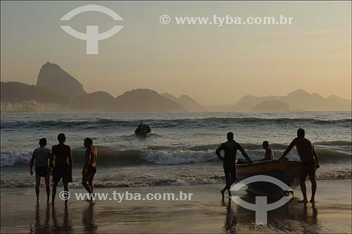  Copacabana Beach with Fishing boats and fishermen in the foreground and Suggar Loaf* in the background - Rio de Janeiro city - Rio de Janeiro state - Brazil - October 2006  *Commonly called Sugar Loaf Mountain, the entire rock formation also include 