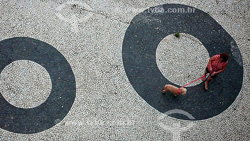  Woman walking with dog at Copacaban sidewalk - Rio de Janeiro city - Rio de Janeiro state - Brazil 