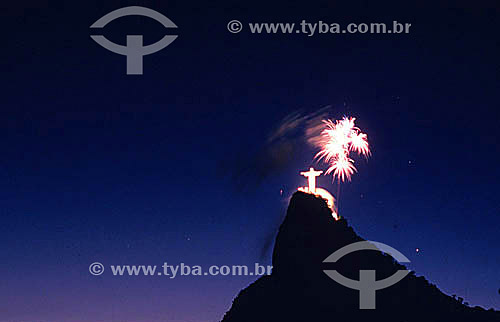  Fireworks bursting above the brightly illuminated Cristo Redentor (Christ the Redeemer) at twilight - Rio de Janeiro city - Rio de Janeiro state - Brazil 