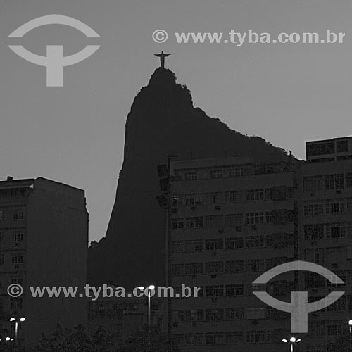  Silhouette of Cristo Redentor (Christ the Redeemer) as seen from Botafogo neigborhood with buildings in the foreground - Rio de Janeiro city - Rio de Janeiro state - Brazil 