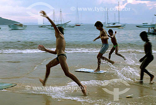  Boys sand surfing on Praia da Armaçao (Armaçao Beach) - Buzios city - Costa do Sol (Sun Coast) - Regiao dos Lagos (Lakes Region) - Rio de Janeiro state - Brazil 