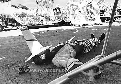  Carnival of Rio de Janeiro, participant sleeping after parade of the samba schools - Rio de Janeiro - Brazil 