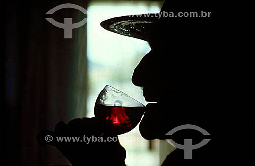 Silhouette of a man taking wine 