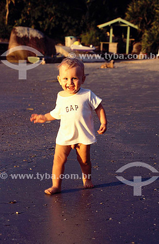  Boy walking at beach 