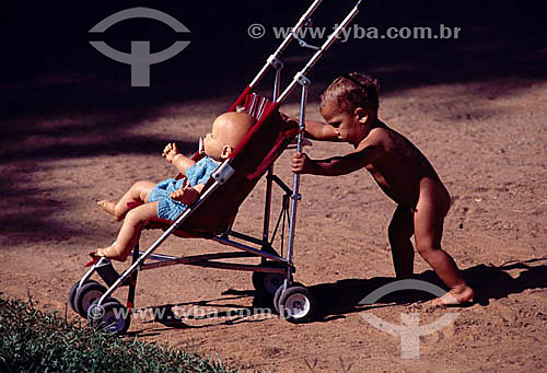  Kid pushing a baby`s car 