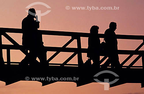  Silhouette of people crossing a path way 