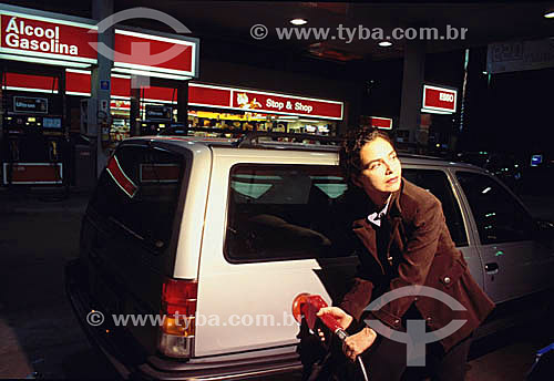  Woman putting gas in the tank 2000 