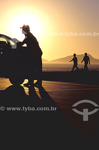  Gas station - Silhouette of a man fulling the tank of the car at sunrise - Rio de Janeiro - Brazil 