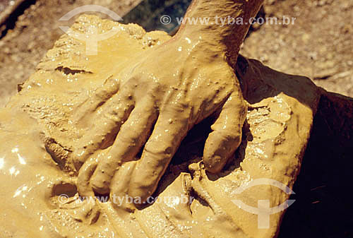  Hand detail in the mud at a gold mine 