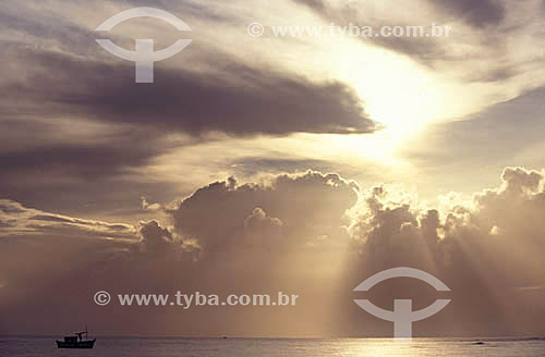  Boat at the sea with the sky full of clouds 