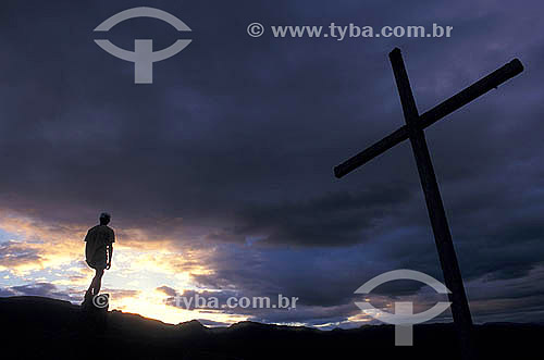  Man and Cross silhouette at a hill - Xique-Xique do Igatu city - Chapada Diamantina Mountain Range - Brazil 
