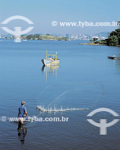 Fisherman throwing fishing net to water at Guanabara Bay - Rio de Janeiro city - Rio de Janeiro state 