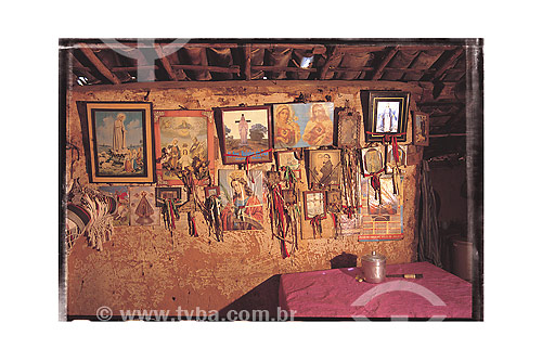  Paintings of religious images hanging on poor house wall 