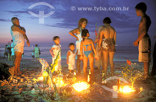  Candles, flowers and other offerings to Iemanjá in the New Year`s Eve beside the people on Copacabana neighbourhood - Rio de Janeiro city - Rio de Janeiro state - Brazil 