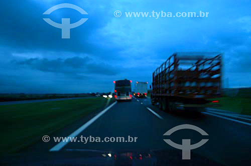 Trucks on a road at night 