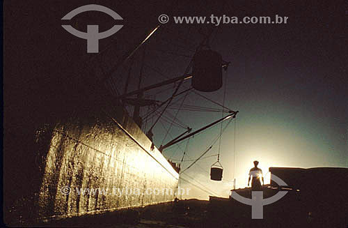  Man near of a cargo ship at seaport during the sunset - Brazil 