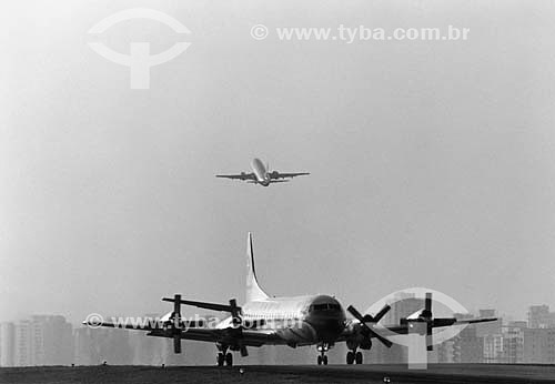  Airplane taking off (in the background) and landed,  the Lockheed Electra airplane, symbol of the flight path from Rio de Janeiro to Sao Paulo during decades, until December 1991. Santos Dumnont Airport - Rio de Janeiro - Brasil  