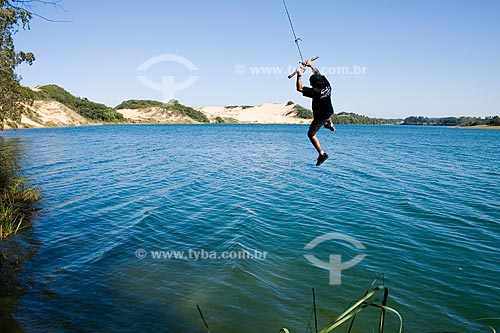  Subject: Young man swinging over Arroio Corrente Lagoon  / Place:  Jaguaruna - Santa Catarina state - Brazil  / Date: 16/08/2009 