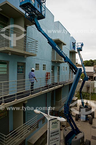  Subject: Growth Acceleration Program (Programa de Aceleracao do Crescimento - PAC) aim to improve the countrys infrastructure - worker painting a building of Candominio Itaoca Housing - Complexo do Alemao  / Place:  Rio de Janeiro city - Rio de Jan 