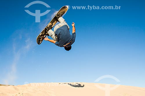  Man practicing sandboarding in the dunes of Joaquina Beach  - Florianopolis city - Brazil