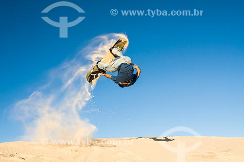  Man practicing sandboarding in the dunes of Joaquina Beach  - Florianopolis city - Brazil