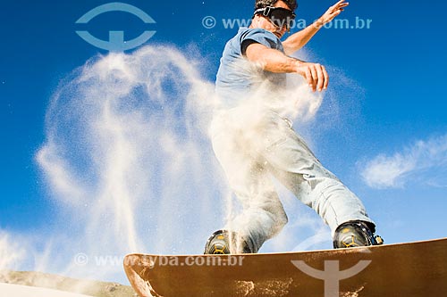  Man practicing sandboarding in the dunes of Joaquina Beach  - Florianopolis city - Brazil