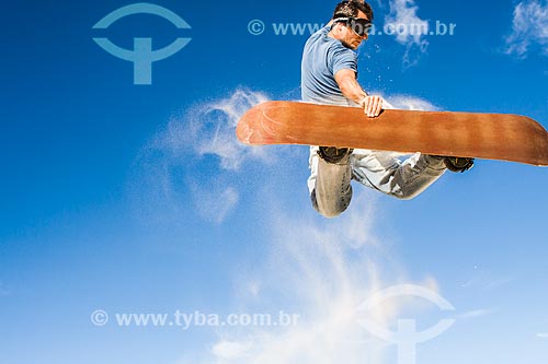  Man practicing sandboarding in the dunes of Joaquina Beach  - Florianopolis city - Brazil