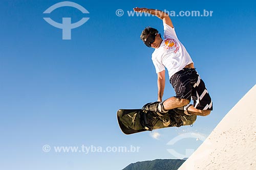  Man practicing sandboarding in the dunes of Joaquina Beach  - Florianopolis city - Brazil