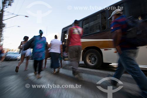  Pedestrians crossing the street with bus on the crosswalk  - Duque de Caxias city - Rio de Janeiro state (RJ) - Brazil