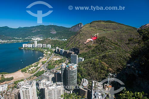  Man preparing strip to slackline - Cantagalo Hill with Christ the Redeemer in the background  - Rio de Janeiro city - Rio de Janeiro state (RJ) - Brazil