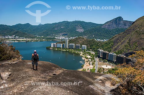  Man - Cantagalo Hill summit with Rodrigo de Freitas Lagoon in the background and Christ the Redeemer (top the left)  - Rio de Janeiro city - Rio de Janeiro state (RJ) - Brazil
