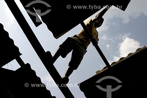  Man putting tiles in house without Personal Protective Equipment  - Porto Velho city - Rondonia state (RO) - Brazil