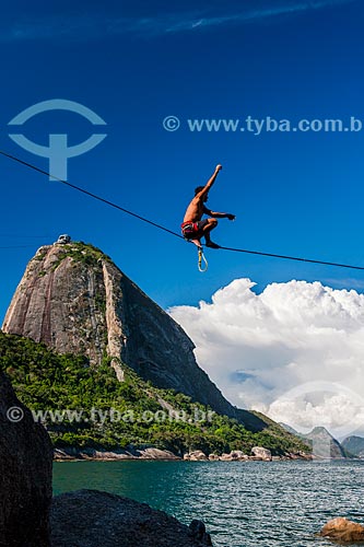  Practitioner of slackline - hill near to Vermelha Beach (Red Beach) with Sugar Loaf in the background  - Rio de Janeiro city - Rio de Janeiro state (RJ) - Brazil