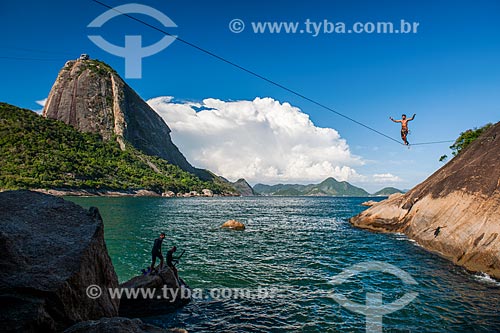  Practitioner of slackline - hill near to Vermelha Beach (Red Beach) with Sugar Loaf in the background  - Rio de Janeiro city - Rio de Janeiro state (RJ) - Brazil