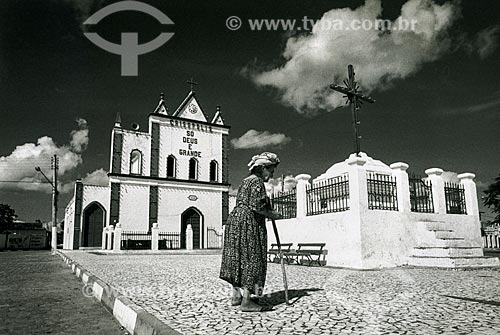  Elderly woman opposite to Matriz Church of Bom Jesus - also known as Conselheiro Church because it was built by Antonio Conselheiro  - Cristopolis city - Bahia state (BA) - Brazil