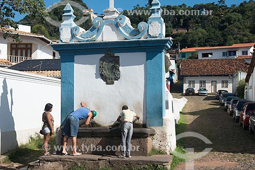  people drinking water - Fountain of the Caquende (1757)  - Sabara city - Minas Gerais state (MG) - Brazil