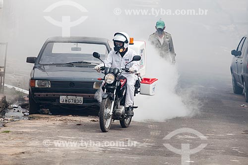  Motorcycle with Ultra-Low Volume (ULV) equipment - also known as cold fogging machine - combat to yellow fever mosquito (Aedes aegypti)  - Manaus city - Amazonas state (AM) - Brazil