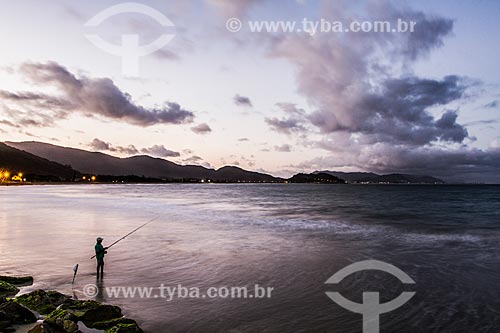  Man fishing at Armacao Beach at dusk  - Florianopolis city - Santa Catarina state (SC) - Brazil