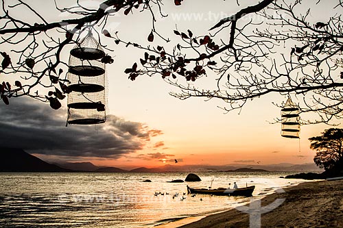  Silhouette of a boat and fisherman at Tapera Beach at sunset  - Florianopolis city - Santa Catarina state (SC) - Brazil