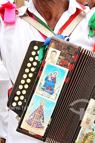  Detail of congada reveler playing accordion during Party to Saint Benedict  - Aparecida city - Sao Paulo state (SP) - Brazil