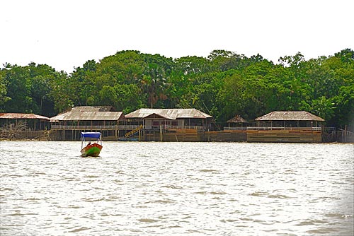  Boat on the Guama River with the community of Combu Island in the background  - Belem city - Para state (PA) - Brazil