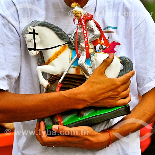  Faithful holding Saint George sculpture - Saint George day  - Rio de Janeiro city - Rio de Janeiro state (RJ) - Brazil