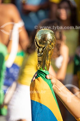  Detail of fan holding replica of FIFA World Cup Trophy - Olympic Boulevard during the match between Brazil x Belgium - World cup 2018 - game in which Brazil was eliminated  - Rio de Janeiro city - Rio de Janeiro state (RJ) - Brazil