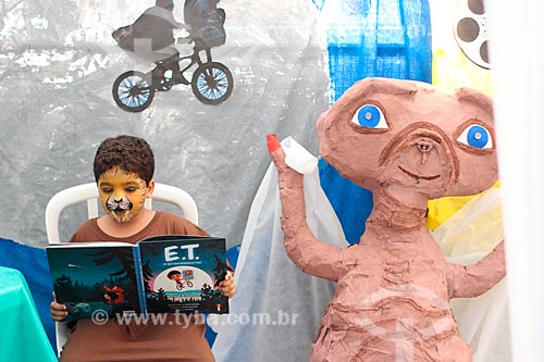  Boy reading during the cultural fair of the Our Lady of the Resurrection School  - Rio de Janeiro city - Rio de Janeiro state (RJ) - Brazil