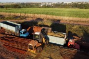 Picture taken with drone of wheel loader loading trucks with sugarcane silage - Mirassol city - Sao Paulo state (SP) - Brazil