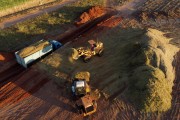 Picture taken with drone of wheel loader loading trucks with sugarcane silage - Mirassol city - Sao Paulo state (SP) - Brazil