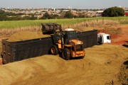 Wheel loader loading trucks with sugarcane silage - Mirassol city - Sao Paulo state (SP) - Brazil