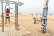 Man exercising on gym equipment on the shore of Copacabana Beach - Rio de Janeiro city - Rio de Janeiro state (RJ) - Brazil