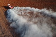 Picture taken with drone of tractor applying limestone for soil correction before planting - Balsamo city - Sao Paulo state (SP) - Brazil